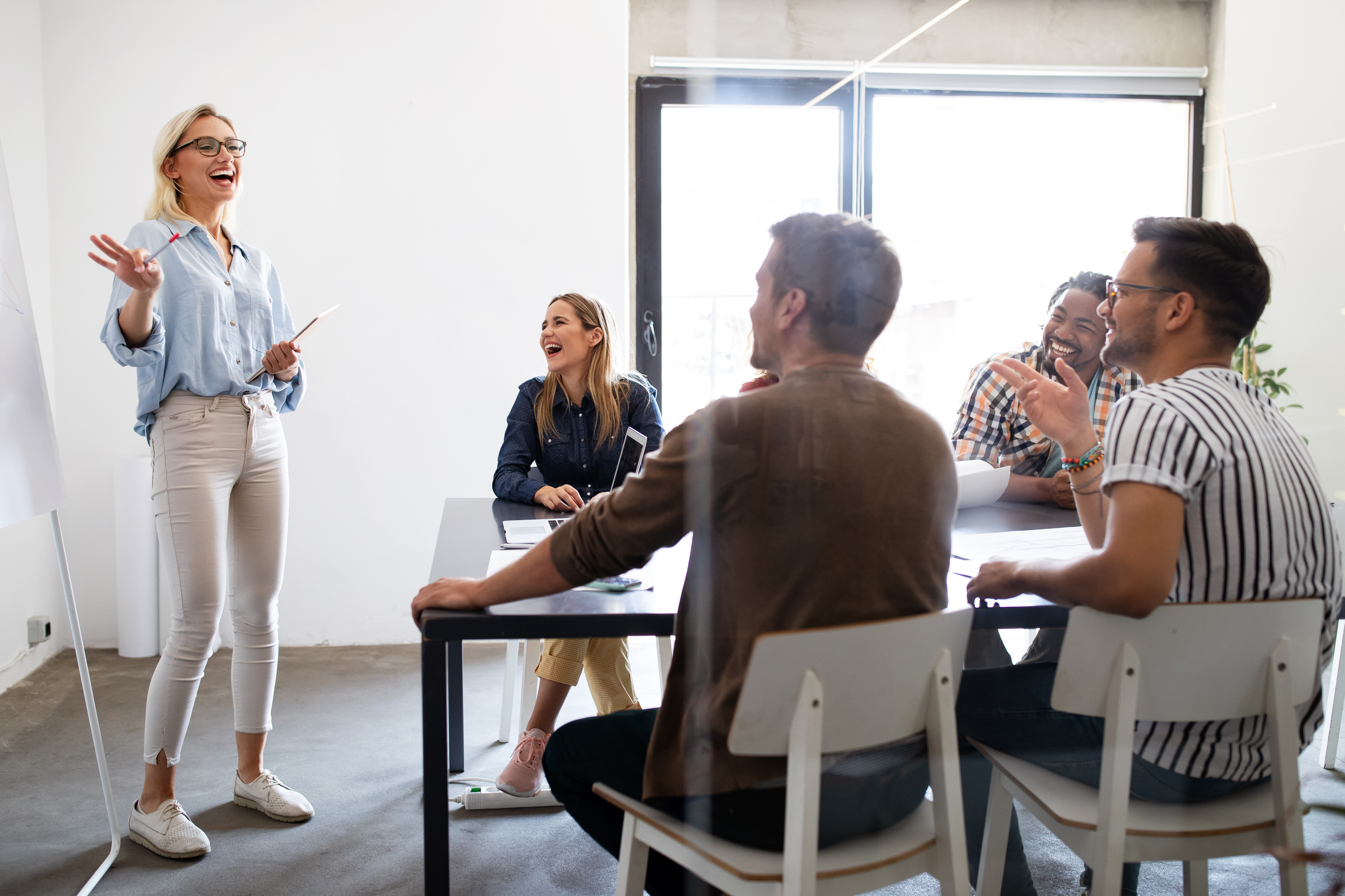 girl leading a business meeting with four coworkers