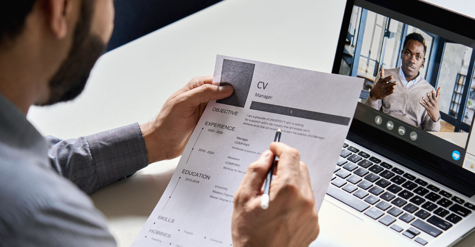 recruiter reviewing resume while interviewing job candidate